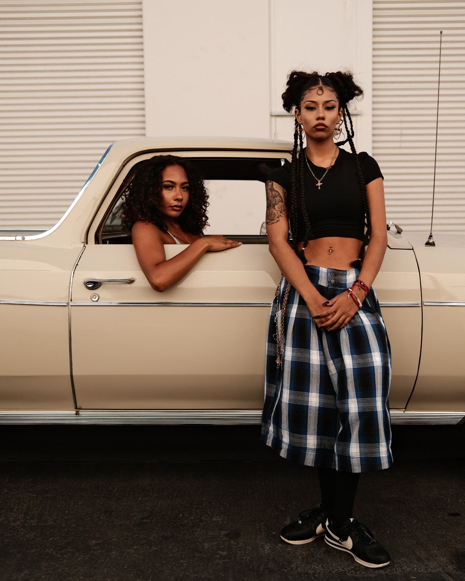 Two figures with a vintage cream pickup truck at golden hour